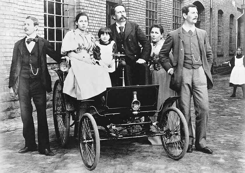 Carl Benz, his two sons (Eugen 1873, Richard 1874), and three daughters (Clara 1877, Thilde 1882, and Ellen 1890) are on their Benz Velo